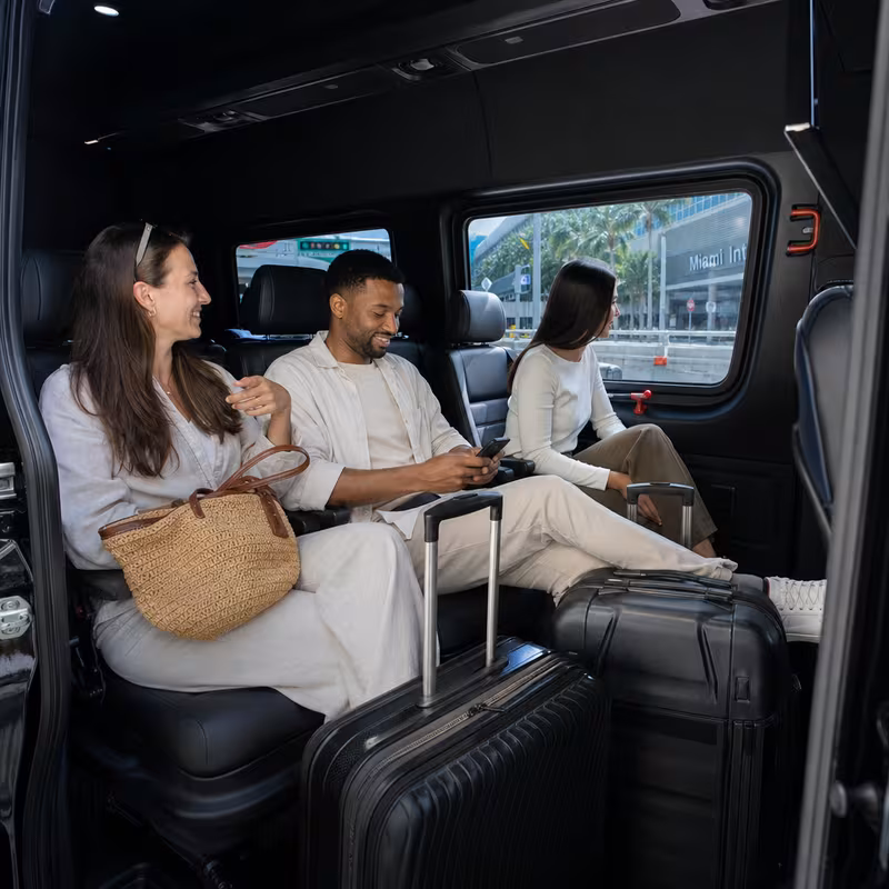 Passengers loading luggage while boarding an Miami group shuttle