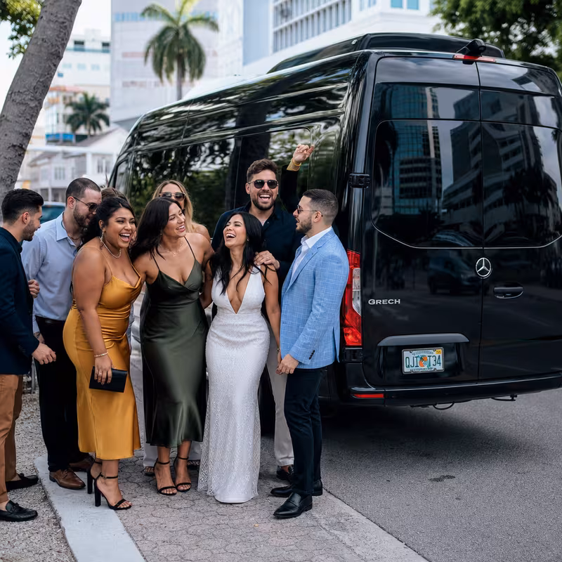 Group boarding a white charter bus for Bachelor & Bachelorette Transportation transportation in Miami