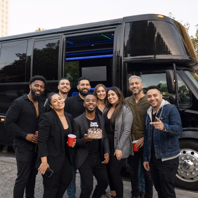 Group boarding a white charter bus for Birthday Transportation transportation in Miami