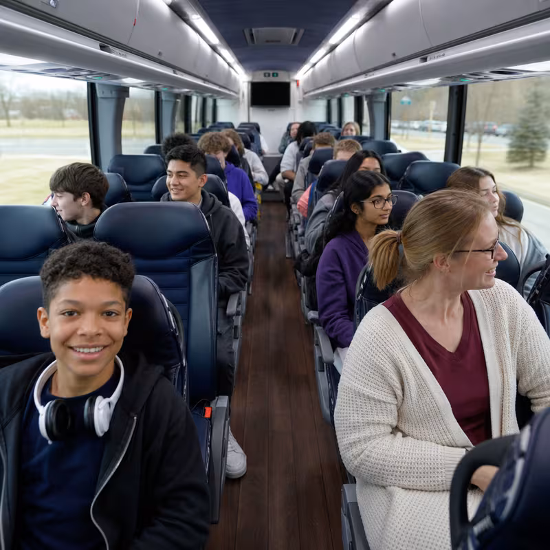 Group boarding a white charter bus for School Transportation transportation in Miami