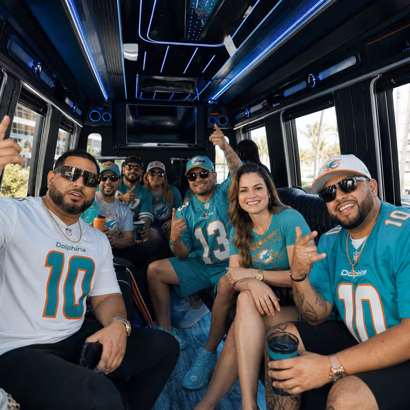 Group boarding a white charter bus for Sporting Event Transportation transportation in Miami