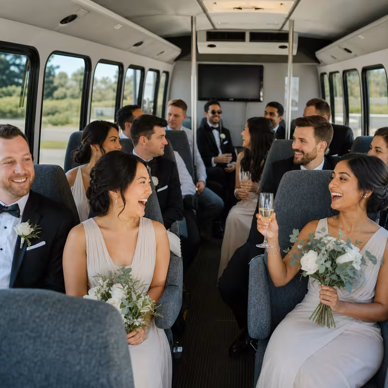 Group boarding a white charter bus for Wedding Transportation transportation in Miami